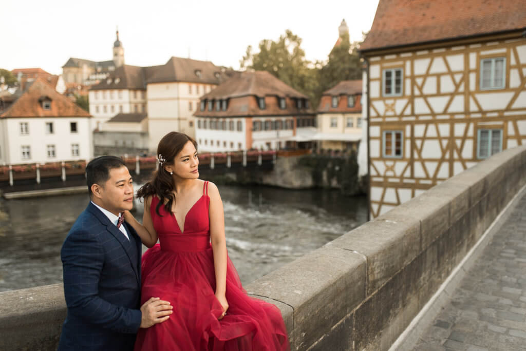 Asian couple for prewedding photos on upper bridge of old town hall in Bamberg